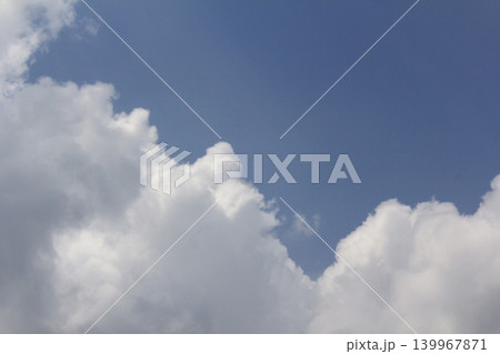 It is a blue sky and white fluffy clouds. 139967871