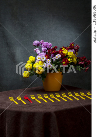 Still life with a bouquet of chrysanthemums in a yellow vase and yellow forks Still life with a bouquet of chrysanthemums in a yellow vase and yellow forks 139969006