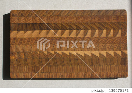 This is a top view of a patterned wooden cutting board. This is a top view of a patterned wooden cutting board. 139970171