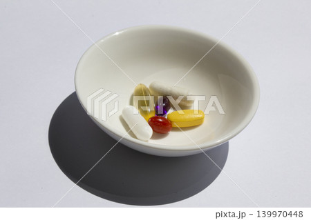 It is pills placed on a small plate. It is pills placed on a small plate. 139970448