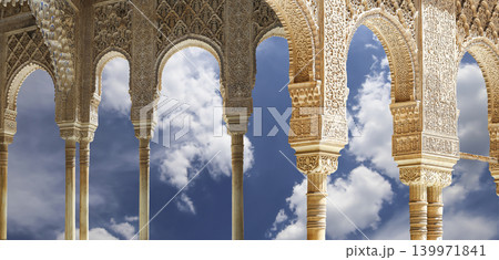 Arches in Islamic (Moorish) style (against the background of a beautiful sky with clouds) in Alhambra, Granada, Spain 139971841