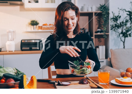 Woman preparing green smoothie in bright kitchen with fresh fruits and vegetables, healthy eating lifestyle moment in natural daylight Woman preparing green smoothie in bright kitchen with fresh fruits and vegetables, healthy eating lifestyle moment in natural daylight 139971940