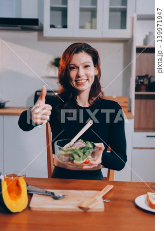 Woman preparing green smoothie in bright kitchen with fresh fruits and vegetables, healthy eating lifestyle moment in natural daylight 139971947