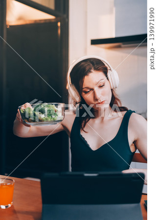 Woman preparing green smoothie in bright kitchen with fresh fruits and vegetables, healthy eating lifestyle moment in natural daylight Woman preparing green smoothie in bright kitchen with fresh fruits and vegetables, healthy eating lifestyle moment in natural daylight 139971990