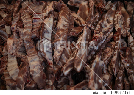 Pork Ribs Cut Portioned Display Shelf Market Sale, A vibrant photo of portioned pork ribs displayed on a market, fresh meat culture and local market, perfect for food documentary and culinary. Pork Ribs Cut Portioned Display Shelf Market Sale, A vibrant photo of portioned pork ribs displayed on a market, fresh meat culture and local market, perfect for food documentary and culinary. 139972351