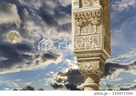 Columns in Islamic (Moorish) style in Alhambra (against the background of a beautiful evening sky with clouds, with the super moon), Granada, Spain Columns in Islamic (Moorish) style in Alhambra (against the background of a beautiful evening sky with clouds, with the super moon), Granada, Spain 139972504
