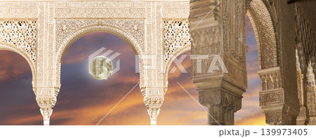 Arches in Islamic (Moorish) style (against the sunset with the super moon) in Alhambra, Granada, Spain Arches in Islamic (Moorish) style (against the sunset with the super moon) in Alhambra, Granada, Spain 139973405