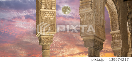 Arches in Islamic (Moorish) style (against the sunset with the super moon) in Alhambra, Granada, Spain Arches in Islamic (Moorish) style (against the sunset with the super moon) in Alhambra, Granada, Spain 139974217