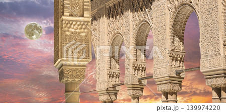 Arches in Islamic (Moorish) style (against the sunset with the super moon) in Alhambra, Granada, Spain Arches in Islamic (Moorish) style (against the sunset with the super moon) in Alhambra, Granada, Spain 139974220