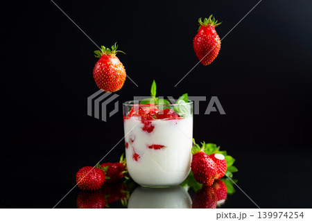 Healthy creamy yogurt with ripe strawberries and mint leaves 139974254