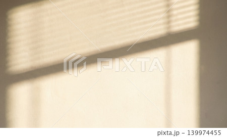 Shadow from window blinds on beige wall background warm minimal aesthetic interior concept light texture backdrop creative simple elegant design template copy space 139974455