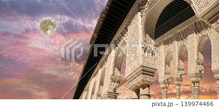 Arches in Islamic (Moorish) style (against the sunset with the super moon) in Alhambra, Granada, Spain Arches in Islamic (Moorish) style (against the sunset with the super moon) in Alhambra, Granada, Spain 139974466