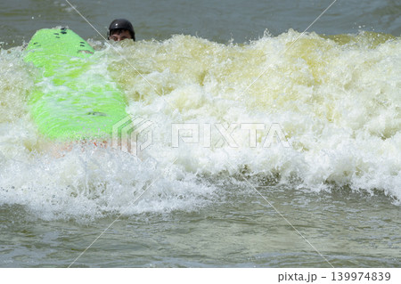 Surfer Falling in Artificial Wave with Green Board Surfer Falling in Artificial Wave with Green Board 139974839