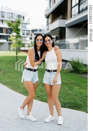 Customers Twin Sisters Smiling in Modern City 139975361