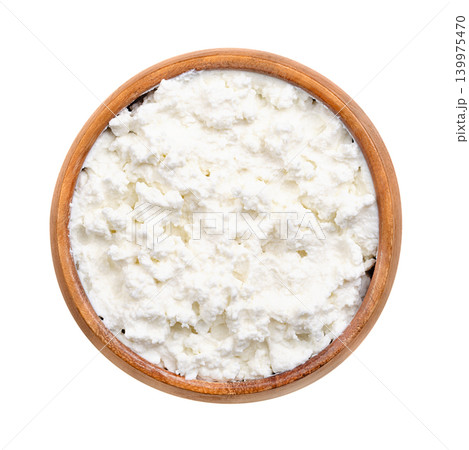Quark, fresh farmers cheese in a wooden bowl. Also called quarg or curd cheese, a dairy product made from milk that is soured by adding lactic acid bacteria cultures and strained after curdling. Photo Quark, fresh farmers cheese in a wooden bowl. Also called quarg or curd cheese, a dairy product made from milk that is soured by adding lactic acid bacteria cultures and strained after curdling. Photo 139975470