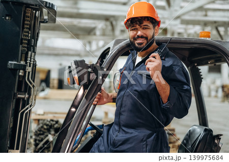 Forklift, machinery to help. Portrait of a male carpenter posing in a woodworking workshop 139975684