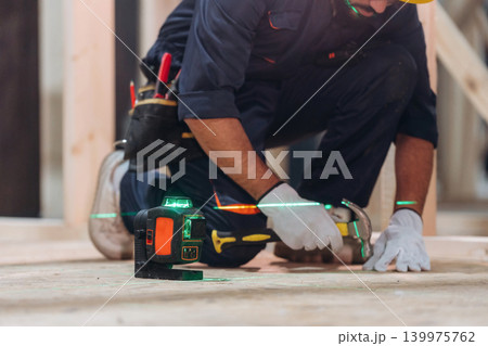 Close-up of a carpenter working with wood using professional tools in a workshop Close-up of a carpenter working with wood using professional tools in a workshop 139975762