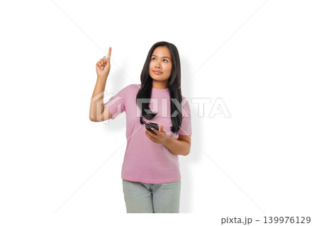 Woman points upward while holding smartphone in hand, PNG Woman points upward while holding smartphone in hand, PNG 139976129