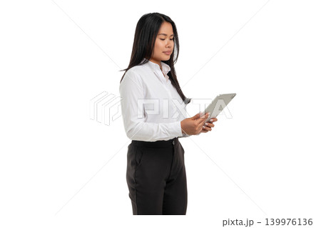 A woman stands while holding a tablet and looking down, PNG A woman stands while holding a tablet and looking down, PNG 139976136