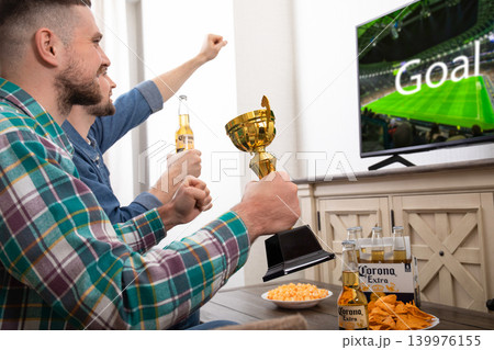 Kiev, Ukraine, March 25, 2026: Watching football with Corona Beer Kiev, Ukraine, March 25, 2026: Watching football with Corona Beer 139976155