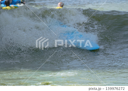 Blue Bodyboard Hidden Under Splashing Artificial Wave Blue Bodyboard Hidden Under Splashing Artificial Wave 139976272
