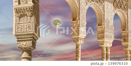 Arches in Islamic (Moorish) style (against the sunset with the super moon) in Alhambra, Granada, Spain 139976310