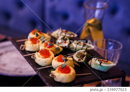 Gourmet Salmon Roe Canapes with Cream Cheese and Caviar Appetizers on Slate Platter Gourmet Salmon Roe Canapes with Cream Cheese and Caviar Appetizers on Slate Platter 139977023
