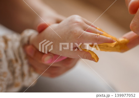 Close Up of Hands Kneading Yellow Modeling Clay or Dough for Creative Art and Sensory Play Close Up of Hands Kneading Yellow Modeling Clay or Dough for Creative Art and Sensory Play 139977052