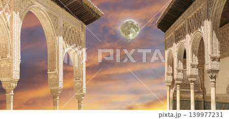 Arches in Islamic (Moorish) style (against the sunset with the super moon) in Alhambra, Granada, Spain 139977231