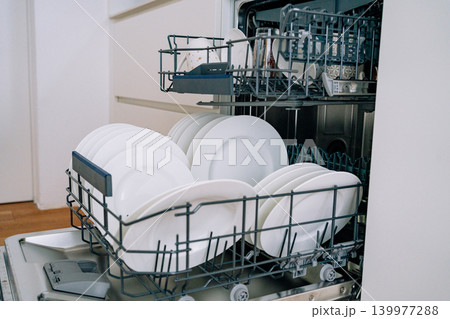 open dishwasher with clean white plates. High quality photo 139977288