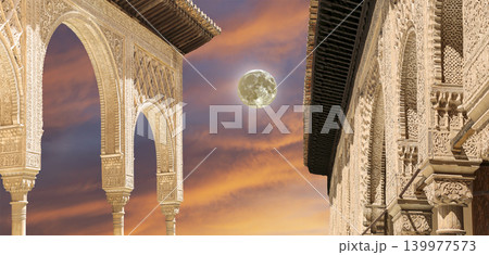 Arches in Islamic (Moorish) style (against the sunset with the super moon) in Alhambra, Granada, Spain Arches in Islamic (Moorish) style (against the sunset with the super moon) in Alhambra, Granada, Spain 139977573