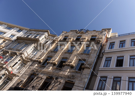 Upward view of a historic ornate stone building facades Upward view of a historic ornate stone building facades 139977940