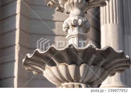 Ornate stone fountain basin captured close-up, highlighting carved scalloped edges Ornate stone fountain basin captured close-up, highlighting carved scalloped edges 139977952