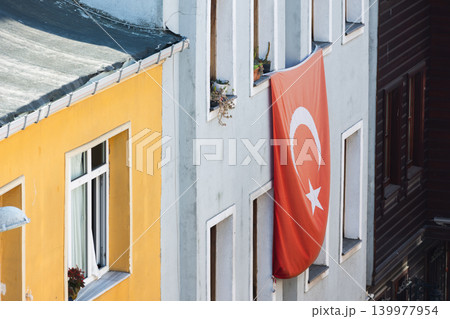 A large Turkish flag hangs from a residential building 139977954