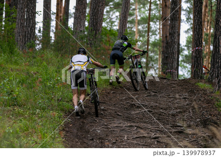 Two athlete of mountain bike walking uphill 139978937