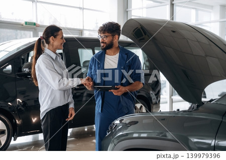 Technical inspection explained to customer indoors Technical inspection explained to customer indoors 139979396