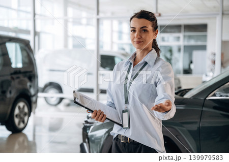 How can I help you conception. Successful automotive consultant standing near car interior 139979583