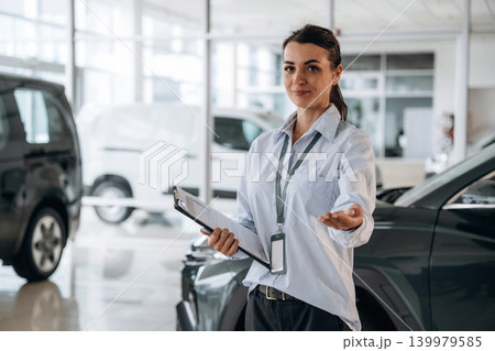 How can I help you conception. Successful automotive consultant standing near car interior 139979585