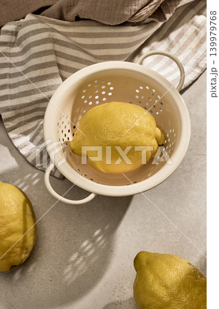 Fresh Lemons in a Vintage Colander with Sunny Shadows. Top View 139979768