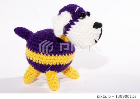Knitted woolen dog on a white background Knitted woolen dog on a white background 139980118