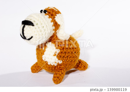 Knitted woolen dog on a white background 139980119