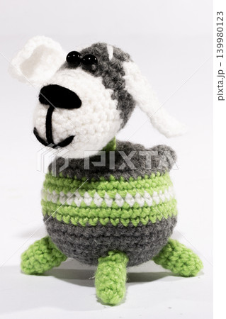 Knitted woolen dog on a white background Knitted woolen dog on a white background 139980123