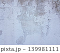 Old wall with peeling paint shows layers of color and texture from years of wear and weather 139981111