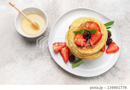 Stack of pancakes with fresh berries and honey 139981776
