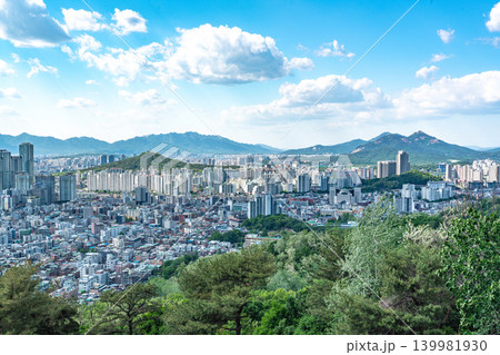 Seoul, South Korea - May. 08, 2026 : Panoramic view of the vast Seoul cityscape, Han River, and fluffy clouds under a clear blue spring sky from Yongmasan Mountain Seoul, South Korea - May. 08, 2026 : Panoramic view of the vast Seoul cityscape, Han River, and fluffy clouds under a clear blue spring sky from Yongmasan Mountain 139981930