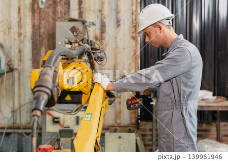 Professional engineer male worker working service inspecting robot machine, Fix replace old part Professional engineer male worker working service inspecting robot machine, Fix replace old part 139981946