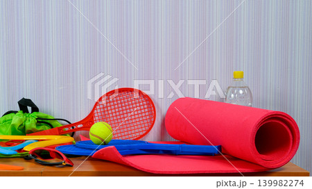 set of various equipment for sports and active games on a table near a wall set of various equipment for sports and active games on a table near a wall 139982274