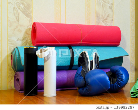 boxing gloves and bottles against a background of mats boxing gloves and bottles against a background of mats 139982287