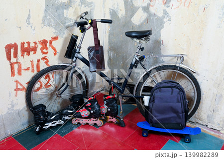 bicycle and roller skates near the old wall 139982289