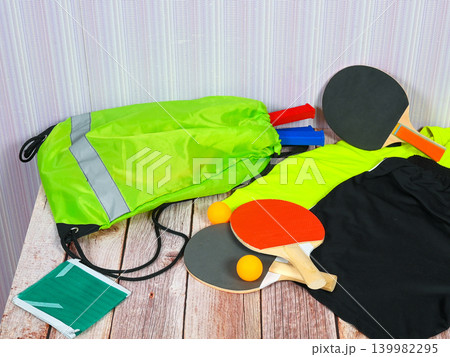 table tennis set with paddles and balls on a wooden table surface 139982295